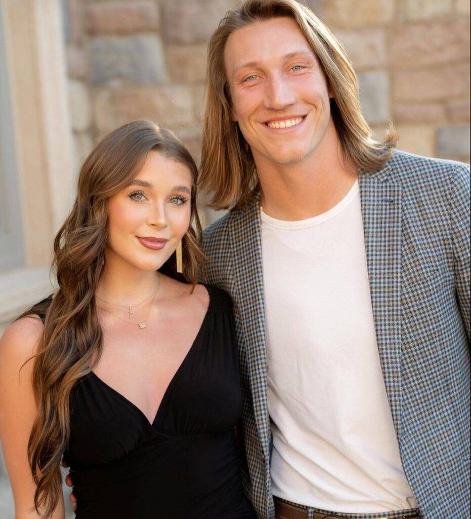 Marissa Mowry in the black outfit with layered necklace while taking picture with her husband