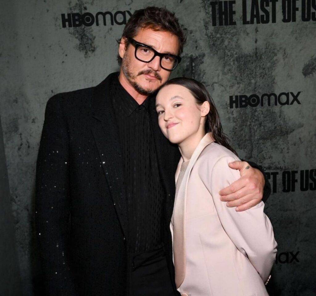 Bella Ramsey in the brown 3-piece suit while taking a photograph with her senior