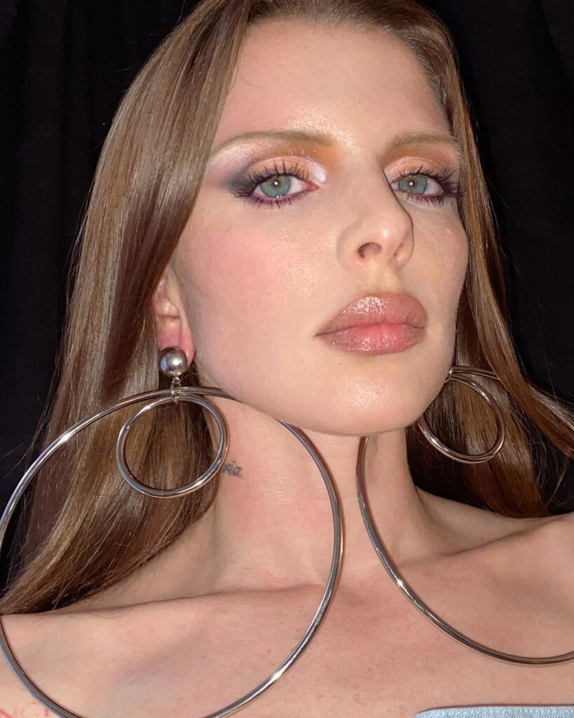 Julia Fox in the large hoops while looking towards camera