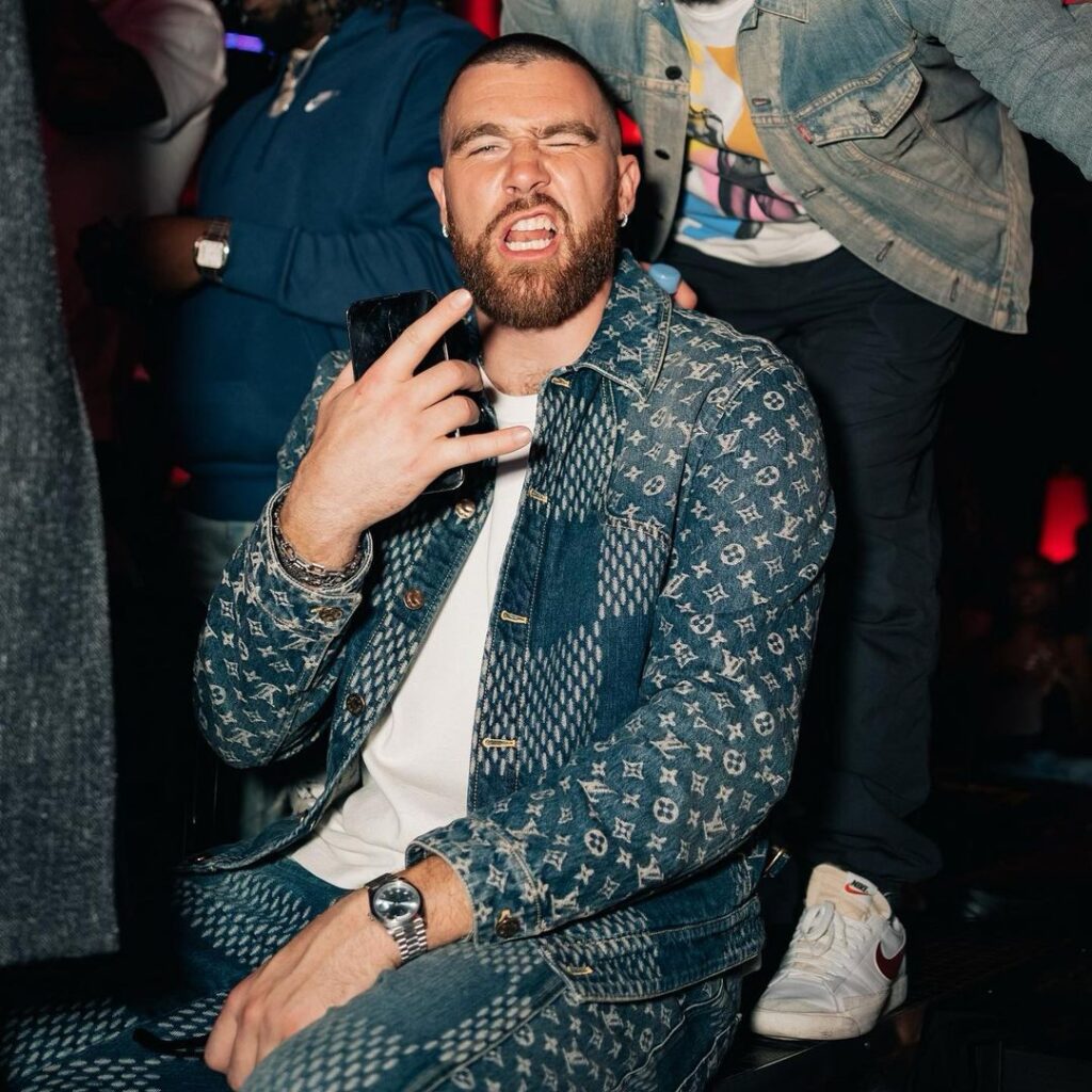 Travis Kelce in the printed denim outfit while poses for a photo and looking towards camera