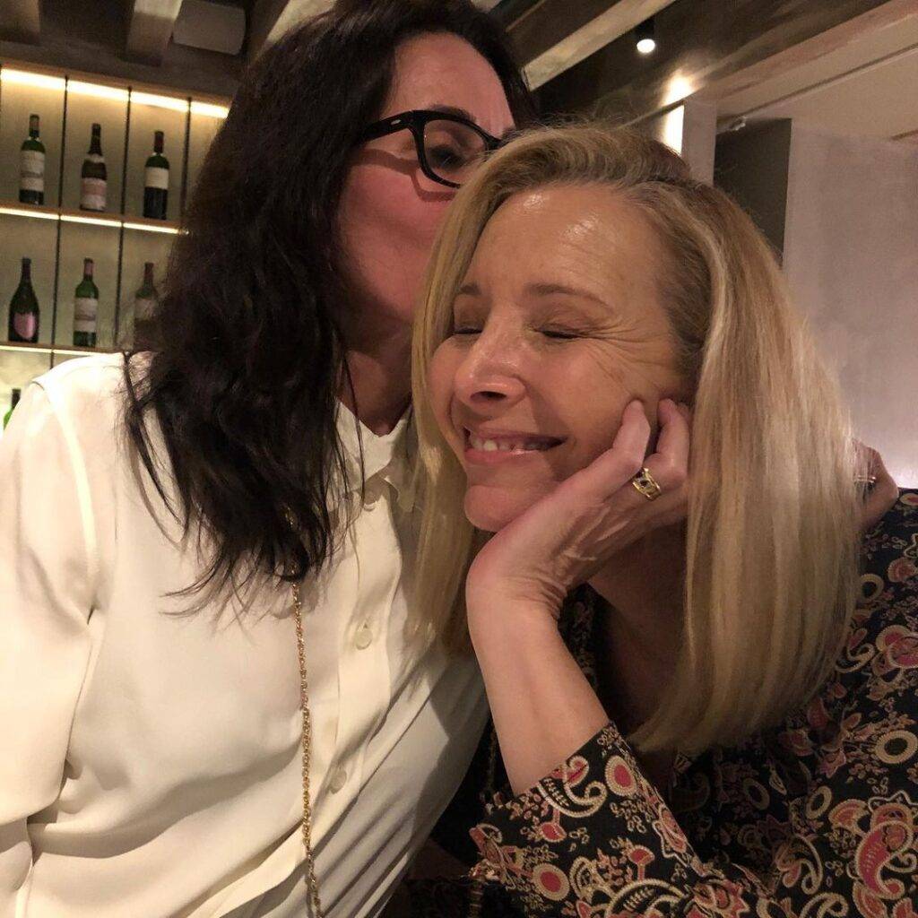 Lisa Kudrow in the black printed outfit while taking picture with her friend, a random click