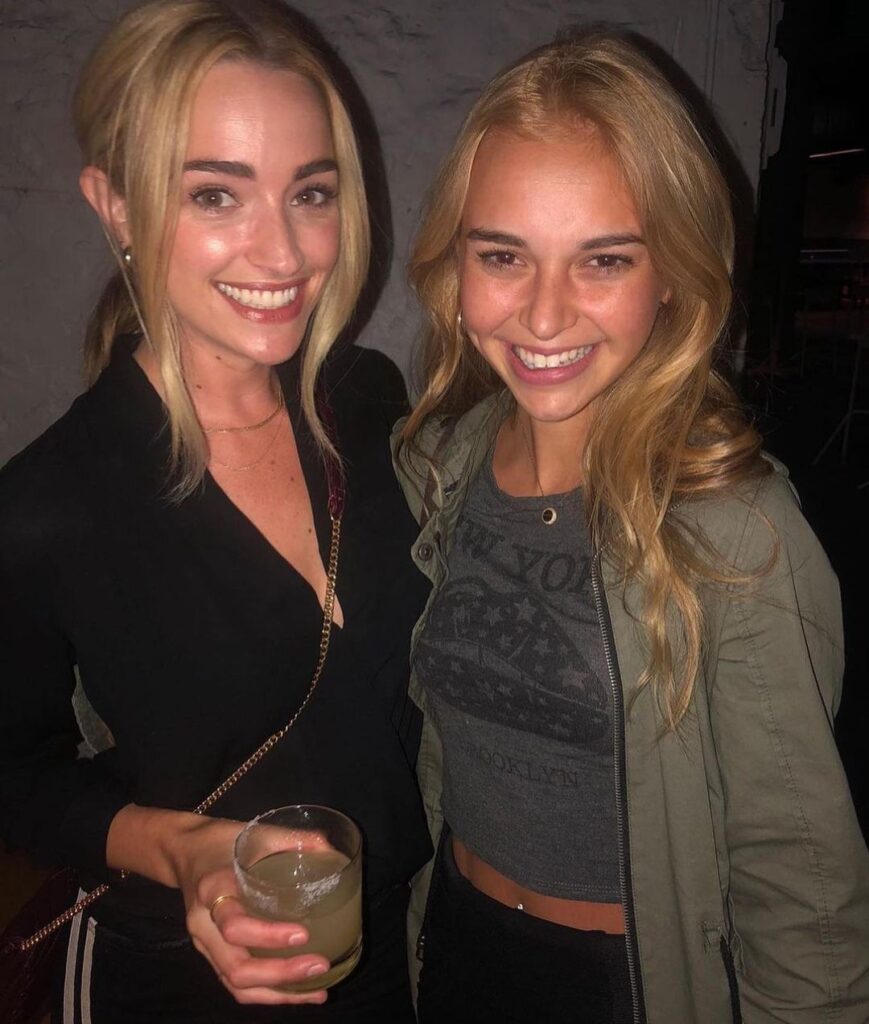 Nikki Oumel in the green crop top pair with black leggings while smiling towards camera