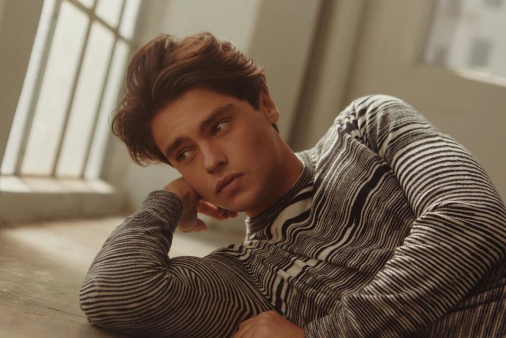 Felix Mallard in the printed black and white shirt while poses for a photo