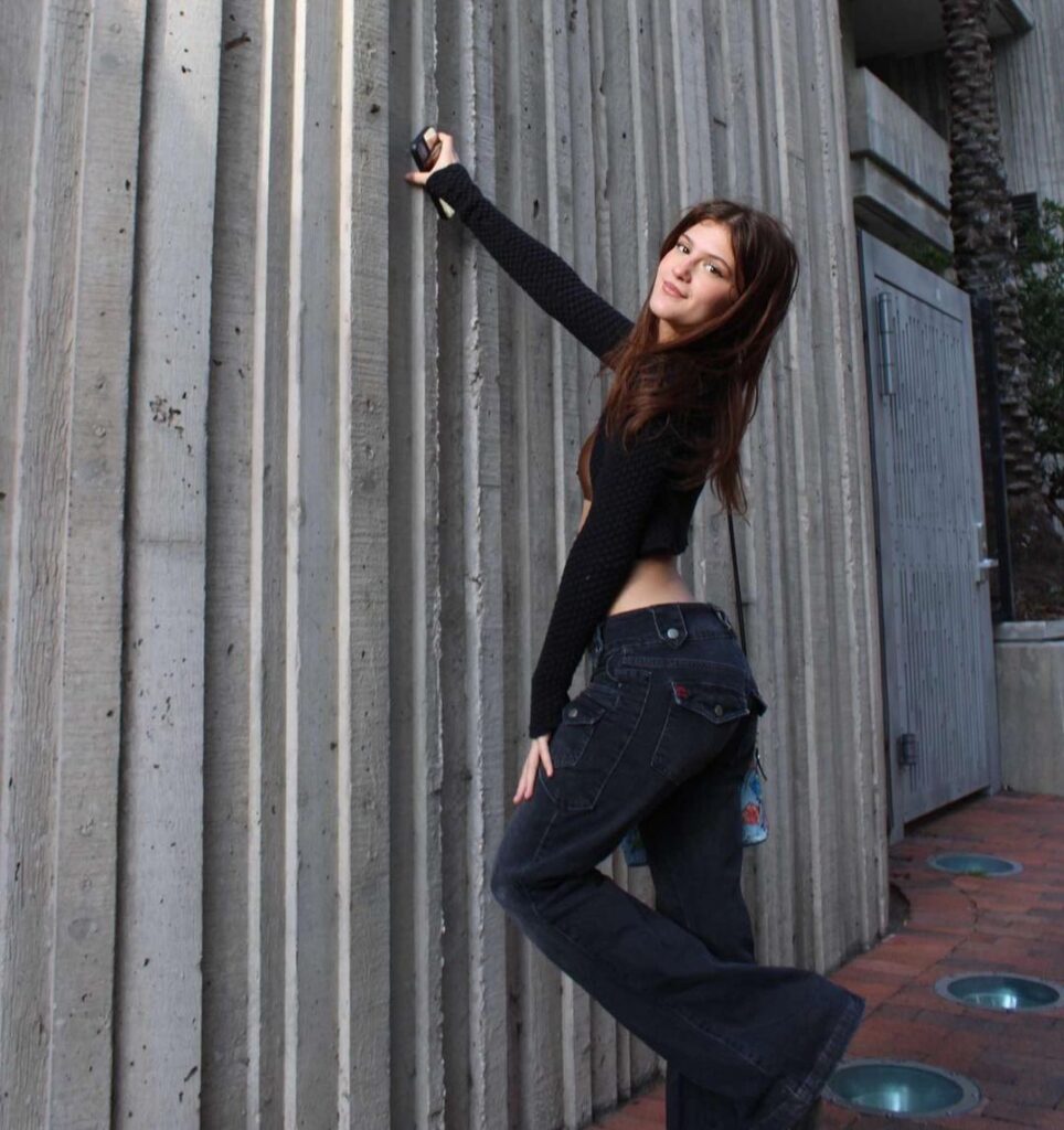 Jenny Roselie in the crop top pair with bell bottom pants while looking towards camera
