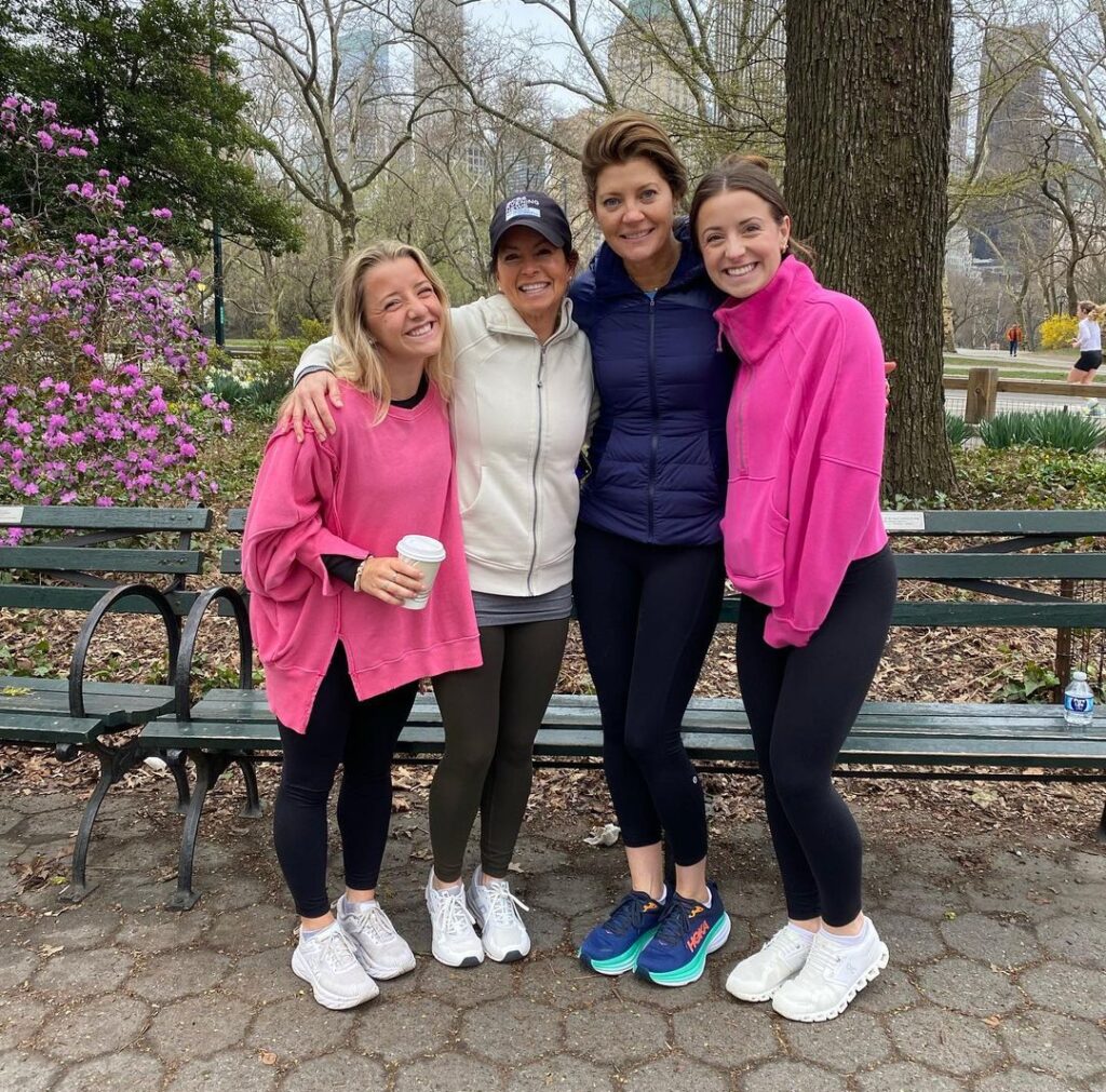 Norah O'Donnell in the navy blue waterproof jacket while taking a group photo with her family