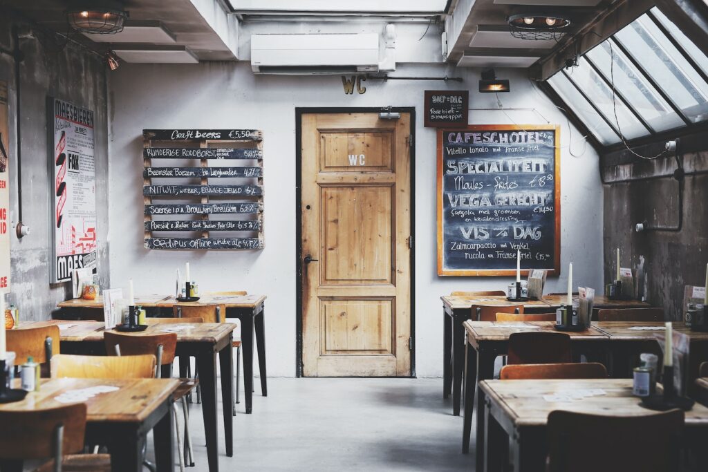 brown wooden door between table and chairs