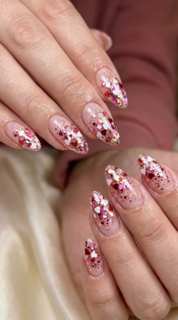 Valentine's confetti glitter nails with red, pink and gold heart sequins