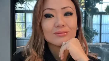 Kathy in the black sweatshirt while smiling towards camera and poses for a photo