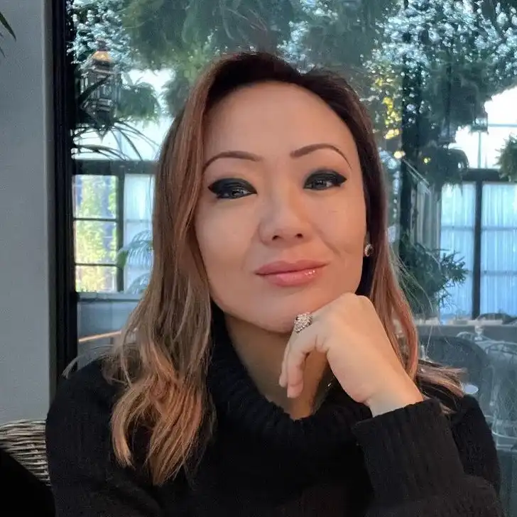 Kathy in the black sweatshirt while smiling towards camera and poses for a photo