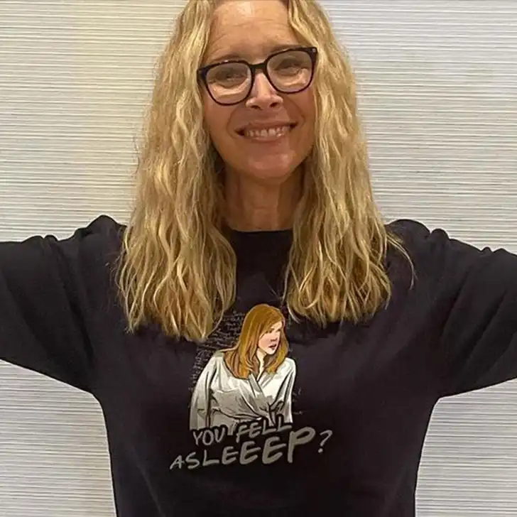 Lisa Kudrow in the black printed, full sleeves shirt while smiling towards camera and poses for a photo