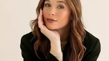 Marissa Layne Lawrence in the black captivating outfit pair with elegant jewellery while looking towards camera