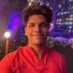 Mithilesh Patankar in the red kurta while taking picture in the outdoors