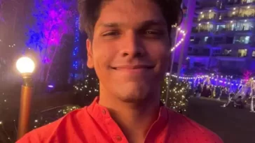 Mithilesh Patankar in the red kurta while taking picture in the outdoors