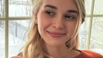 Nikki in the beautiful brown outfit while holding a cup in her hand