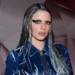 Julia Fox in the blue outfit while looking towards camera and poses for a photo