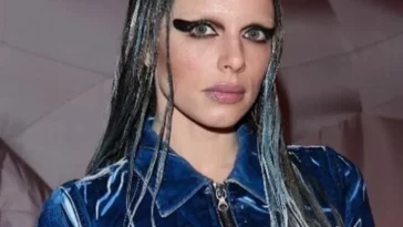 Julia Fox in the blue outfit while looking towards camera and poses for a photo