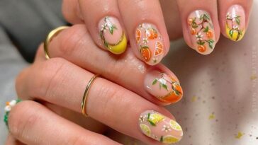 Short nails with fruit nail art using orange, yellow, and pink nail paint