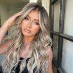 Tyler James Williams in the black captivating outfit pair with chain necklace while looking towards camera