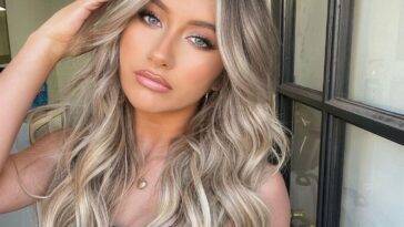 Tyler James Williams in the black captivating outfit pair with chain necklace while looking towards camera