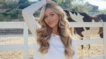 Emily Dobson in the white crop top pair with pant while giving hot pose towards camera