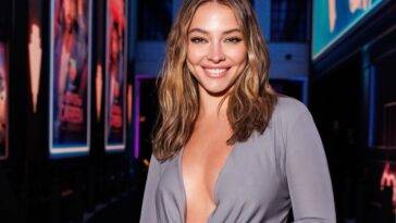 Madelyn Cline in the sexy grey outfit pair with chain watch while smiling towards camera