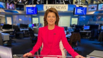 Norah O'Donnell in the pink sexy outfit and brown shoes while poses for a photo